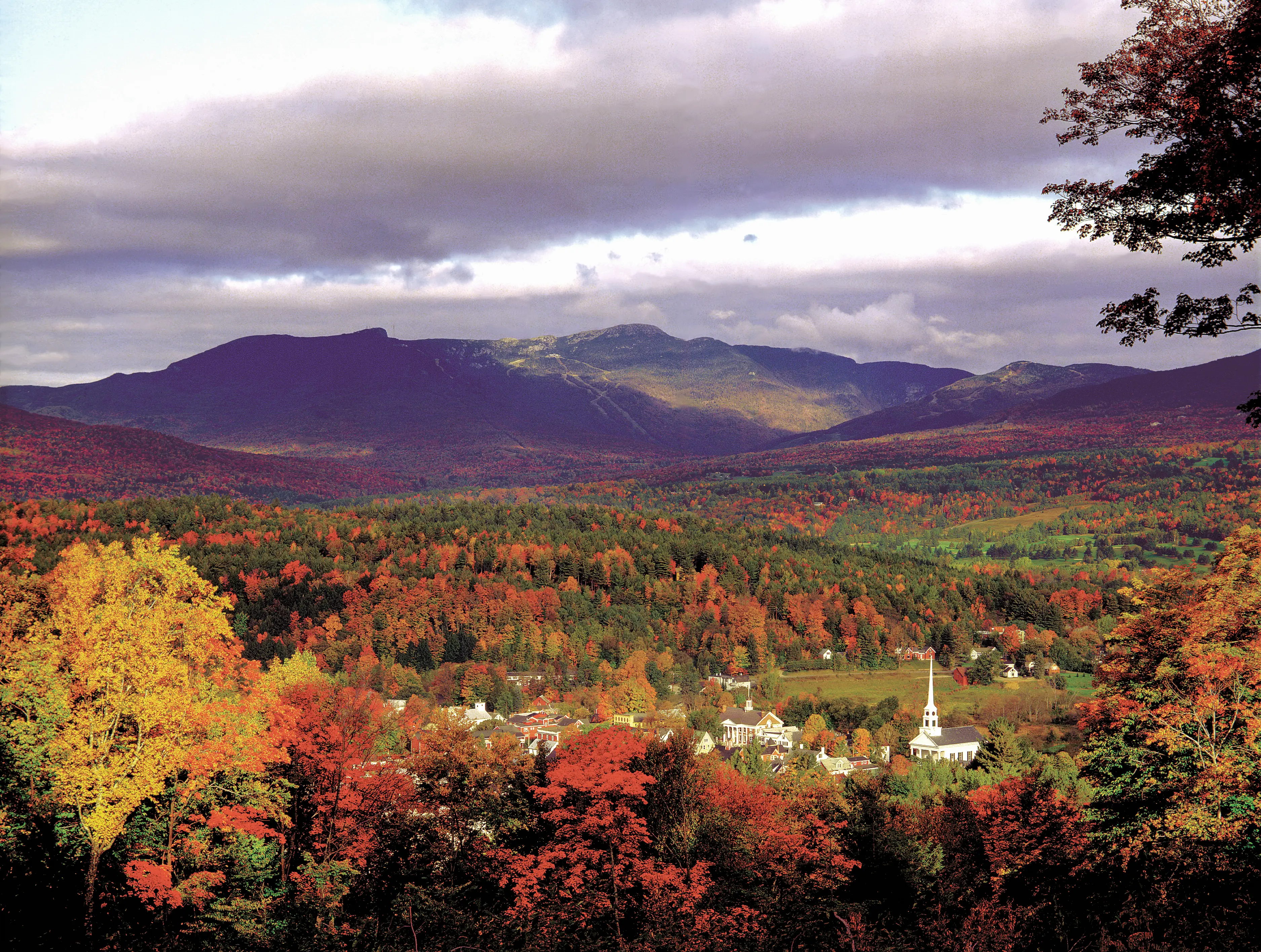 Aerial image of the fall foliage surrounding the town of Stowe, Vermont.