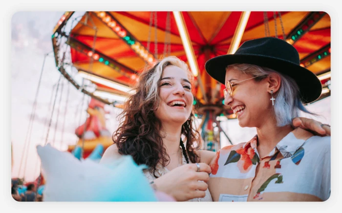  A couple walking around a fair and eating cotton candy