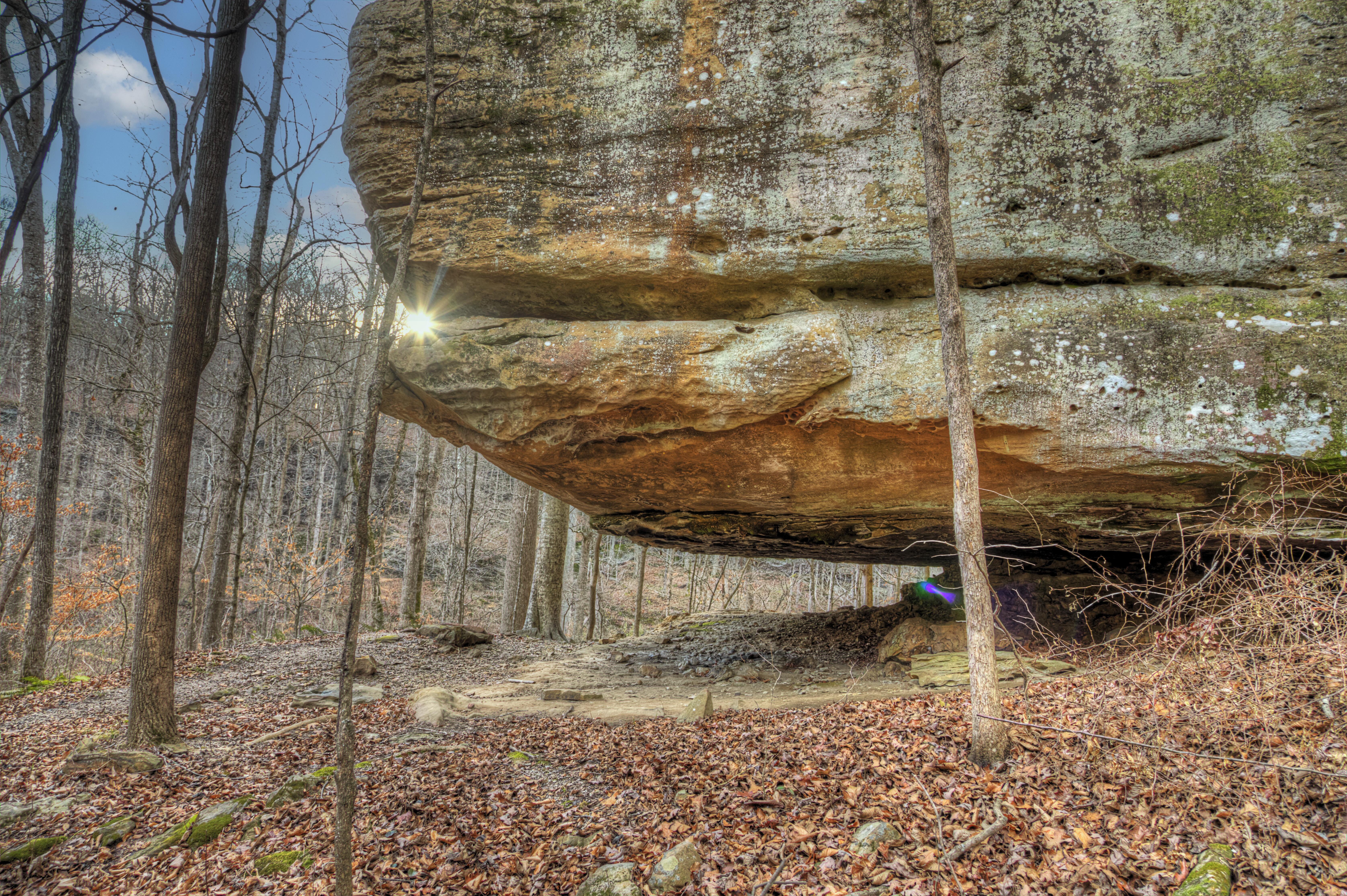 Image of a beam of light glowing through the crack of a boulder in Shawnee National Forest, Illinois.