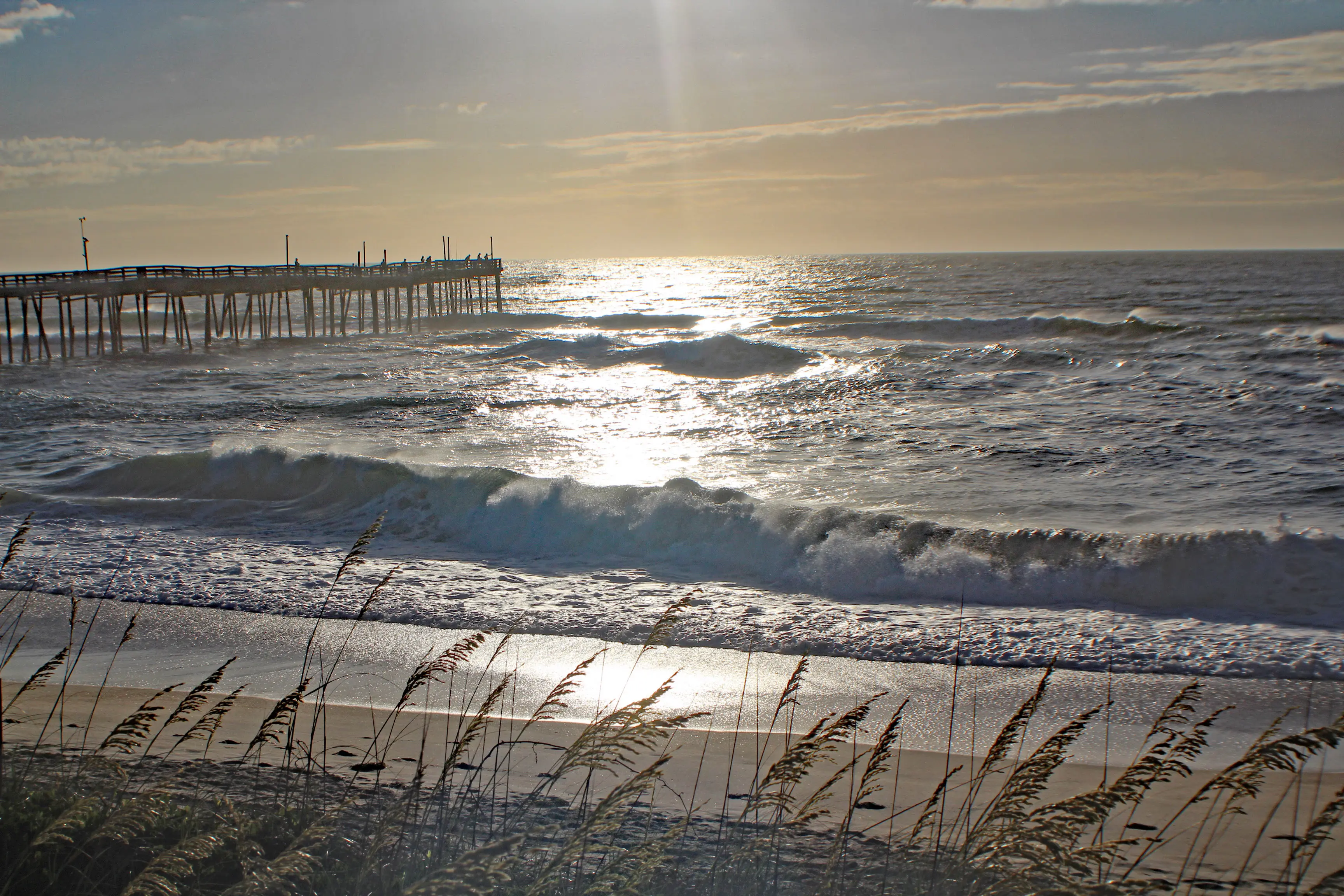 Image of Avon Beach in the morning, with an old pier visible above the shore.