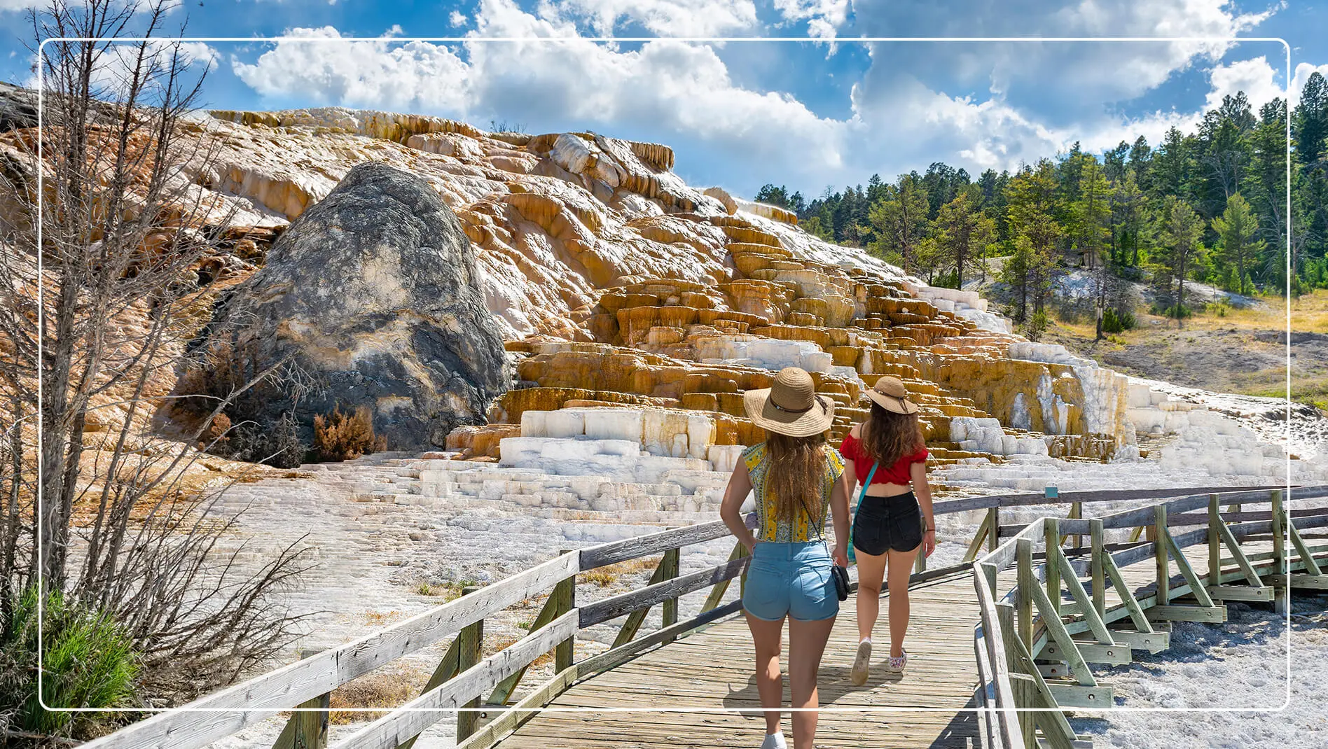 Two women walking by the hot springs in Yellowstone National Park.