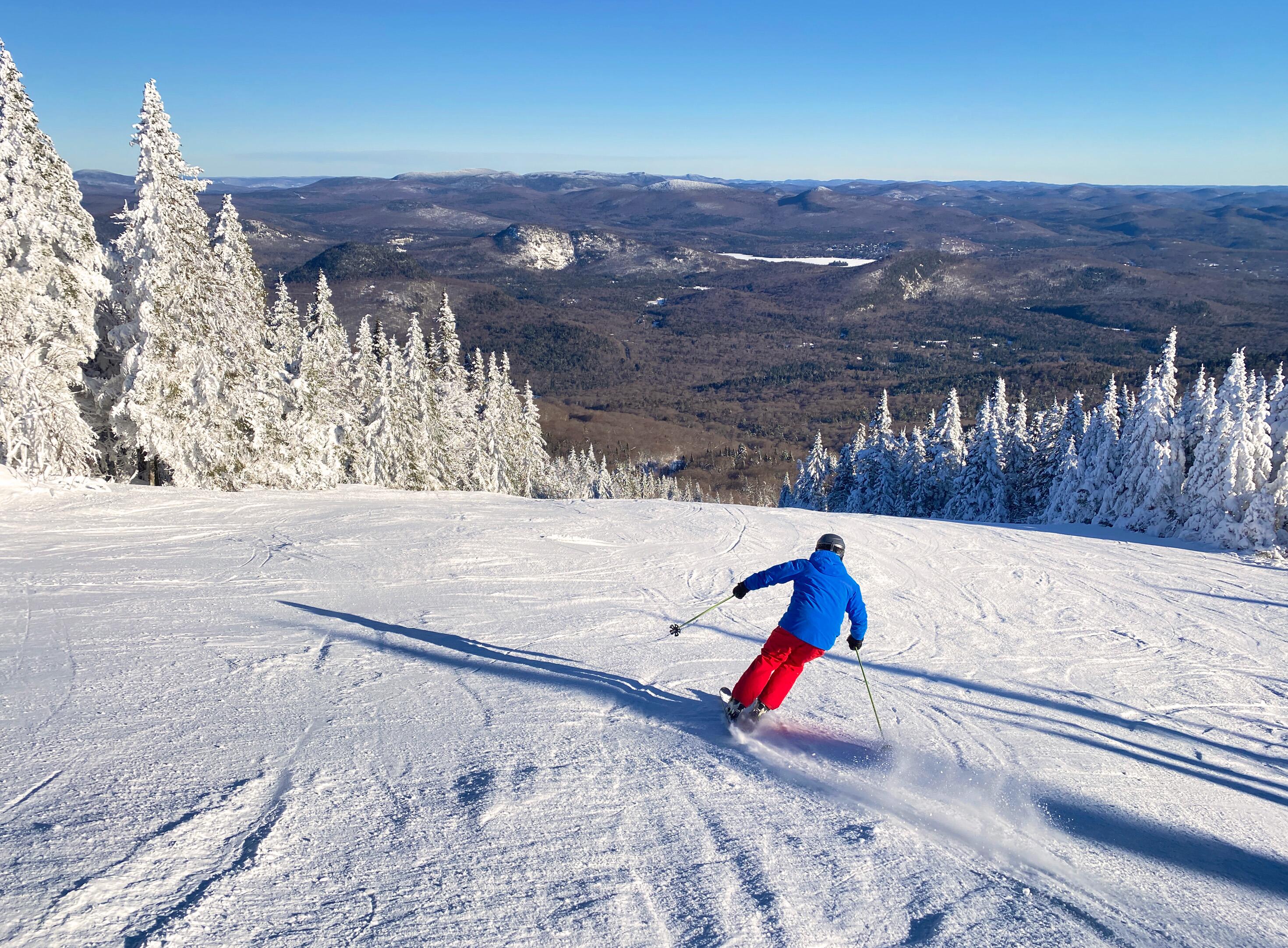 Skier going down the snowy Mont Tremblant summit, Quebec, Canada