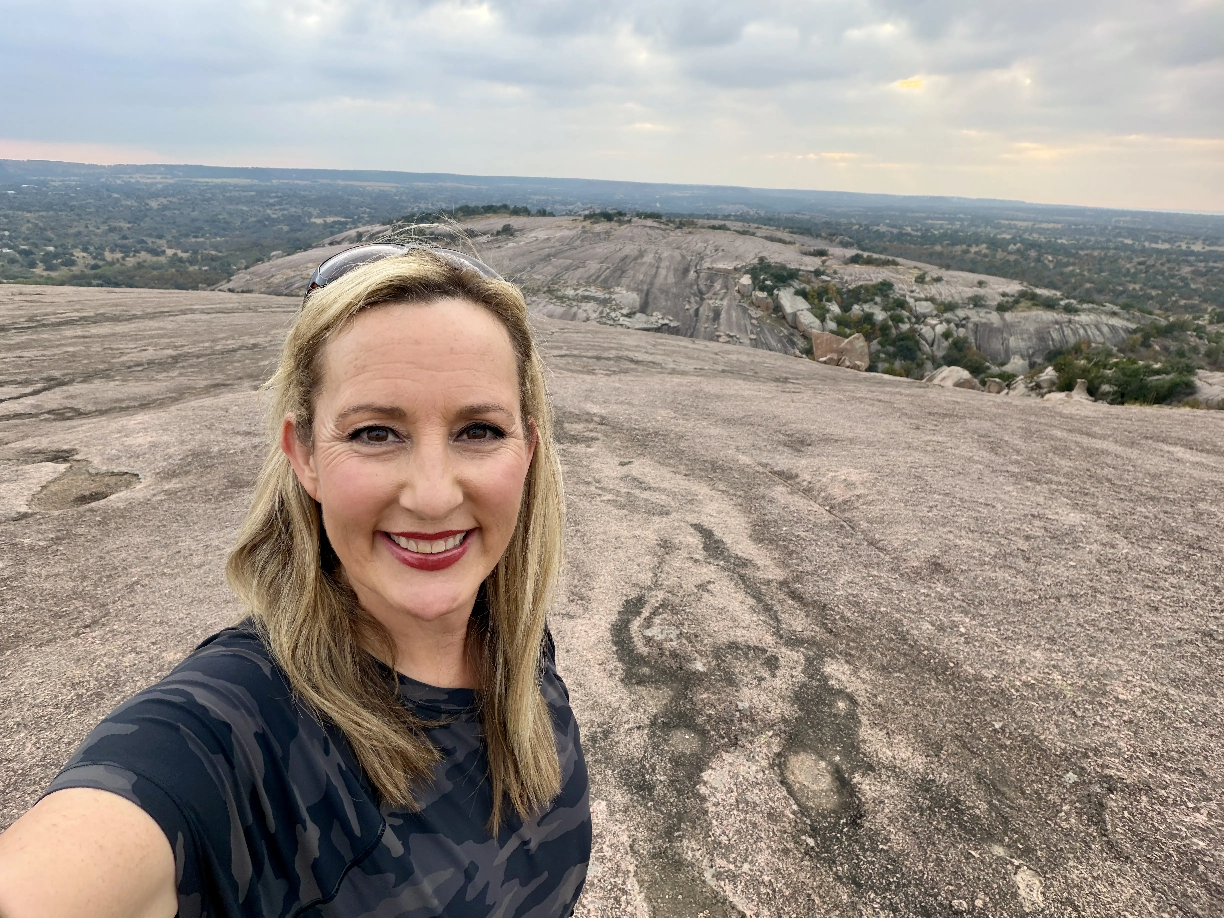 Woman with blond hair on a hike in Enchanted Rock State Natural Area